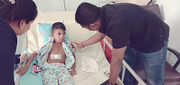 A LIFE Malaysia volunteer visits a young heart-surgery patient, 2018