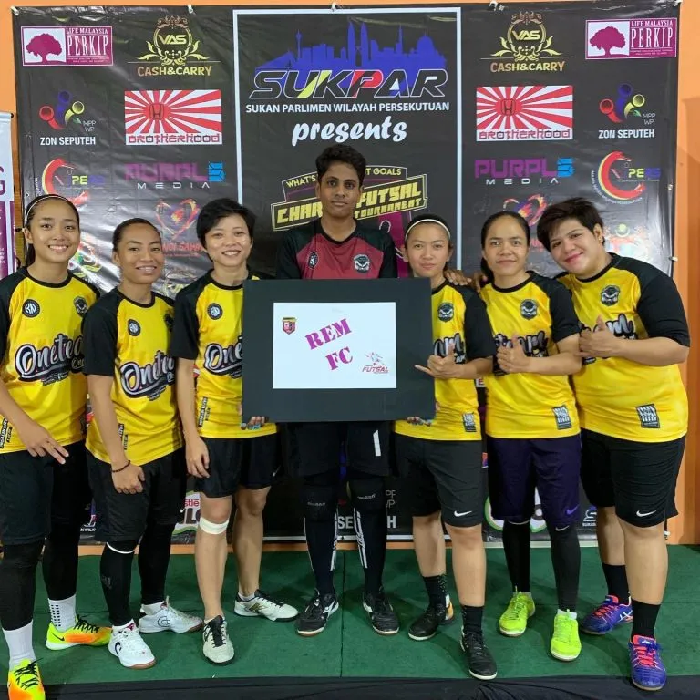 Women's team with their placard at the 2019 charity futsal