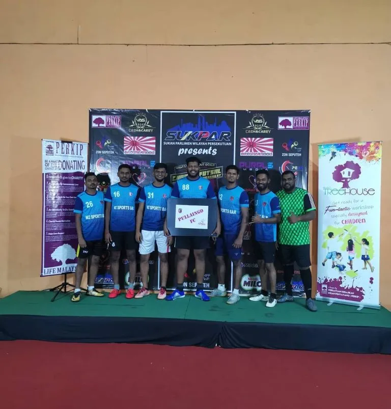 Team photo on stage at the LIFE Malaysia charity futsal